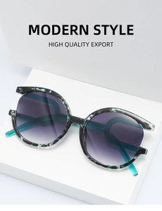 Detail of round sunglasses with dark green floral frames and purple gradient lenses