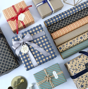 Detailed view of various geometric gift wrapping paper rolls with decorative ribbons