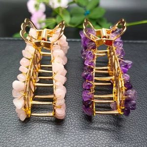 Detail of handmade gold hair claws with natural pink quartz and purple amethyst stones