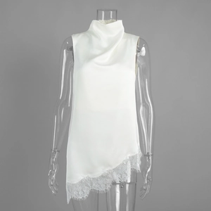 Detail view of the elegant satin fabric texture and irregular white lace hem on the top