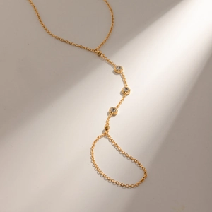 Elegant 18k gold plated stainless steel ring bracelet with three inset crystals on white surface