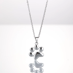 Macro shot of silver stainless steel paw print pendant necklace with high-polished mirror finish