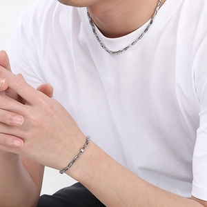 Male model wearing silver stainless steel rectangle buckle necklace and bracelet set