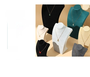 Various necklace display stands in velvet and linen textures with mannequin neck curves