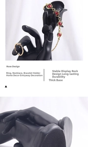 Detailed view of resin hand jewelry display stand with rose design and non-slip base