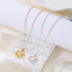 Detail view of gold and silver hollow flower pendants on fine stainless steel necklaces