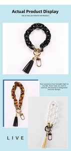 Detail of acrylic chain wristlets in black, tortoiseshell, and white with tassels