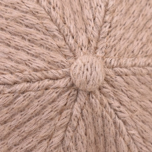 Close-up of beige knit pattern and top reinforcement on the warm winter baseball cap