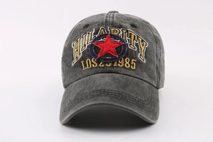 Detailed close-up of vintage washed dark gray baseball cap with red star and hilarity embroidery