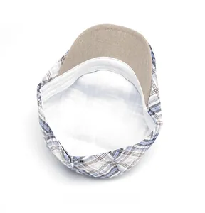 Detail view of plaid newsboy cap interior featuring breathable lining and sweatband