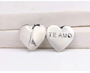 Macro detail of open heart locket with Eiffel Tower engraving and Te Amo text