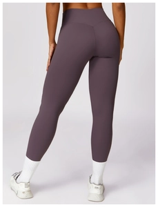 Rear view detail of high-waist yoga leggings showing V-shaped back seam in dark purple