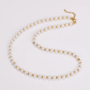 Detail of vintage pearl necklace with gold spacer beads and secure lobster clasp closure