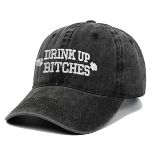 Close-up of vintage washed baseball cap with white embroidery and shamrock side detail