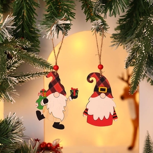 Christmas wooden gnome ornaments with plaid hats and red beads hanging on a pine tree