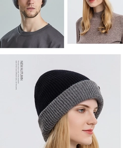 Detail view of double-sided black and grey knitted beanie with warm thermal texture