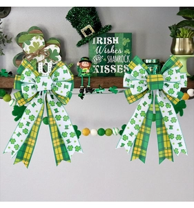 Detail of St. Patrick's Day bows with clover prints and green plaid hanging on wood