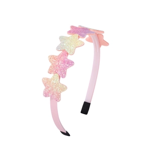 Close-up of pink fabric headband featuring glittery sequined stars and protective tips