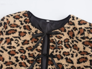 Detail of leopard print fleece jacket collar with black satin trim and ribbon tie closure