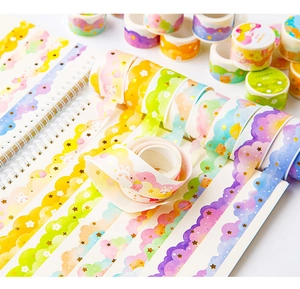 Detail of scalloped edge cloud and rainbow washi tape on a white spiral notebook