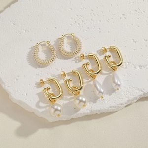 Elegant gold pearl earring set featuring geometric hoops and classic French style charms