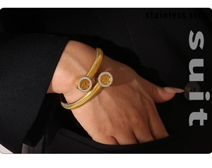 Detail of 18k gold plated tree of life bangle with rhinestones on a stainless steel cuff