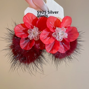 Macro shot of red acrylic flower earrings with plush pom-poms and S925 silver needles
