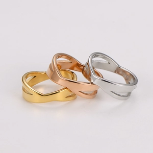 Three-color stainless steel crossover rings in gold, rose gold, and silver finishes
