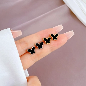 Minimalist titanium steel butterfly studs in gold and silver with black enamel finish