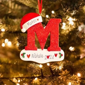 Custom red glitter letter M Christmas tree ornament with Santa hat on a festive branch