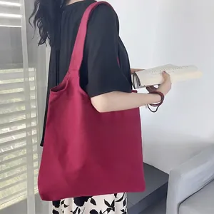 Solid deep red canvas tote bag with thick shoulder straps for daily use