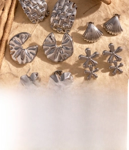 Detail view of steel heart and shell flower earrings featuring vacuum plating finish