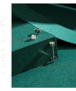 Detail of S925 sterling silver stud earrings with four-prong set sparkling moissanite