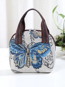 Ethnic style jacquard handbag with vibrant blue butterfly pattern and woven handles