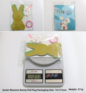 Close-up of Easter macaron rabbit banner set on a scale showing 27.1g weight detail