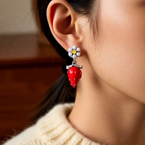 Detailed shot of strawberry pendant earring with pearl flower and red berry charm