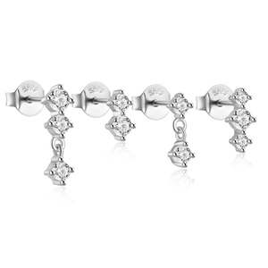 Macro view of four S925 sterling silver bow earrings with sparkling cubic zirconia studs