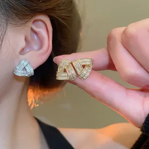Crossed triangle stud earrings with sparkling cubic zirconia in gold and silver plating