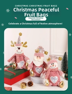 Detailed view of pink velvet Christmas gift bags with reindeer and Santa designs