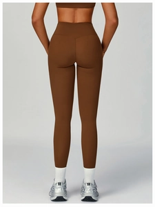 Back view of high waisted chocolate brown yoga leggings with matte finish on model