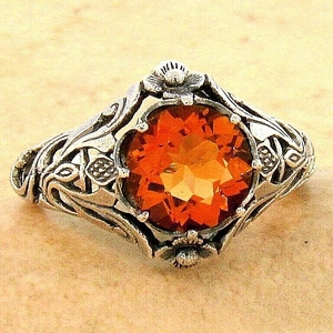 Vintage silver finish ring featuring a large round orange gemstone with floral texture