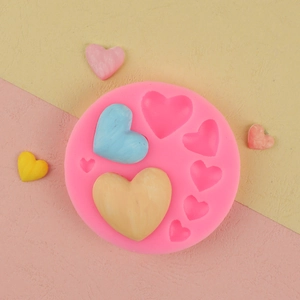 Pink silicone mold with heart shapes for DIY chocolate and cake decoration projects