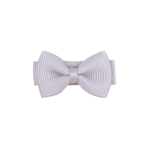 Detailed close-up of a white grosgrain ribbon hair bow clip for girls on white background