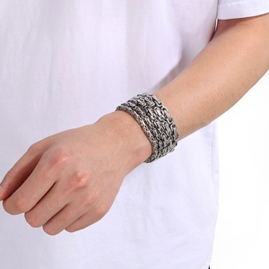 Detail of silver Byzantine chain bracelet with industrial design on a man's wrist