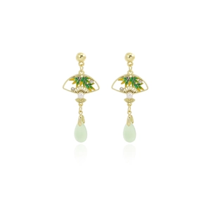 Detailed macro shot of a green fan-shaped earring with golden frame and pearl accent