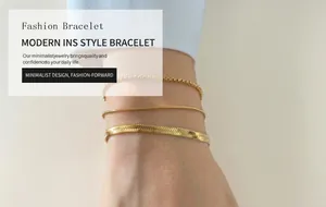 Macro view of three layered gold snake and box chains styled on a female wrist