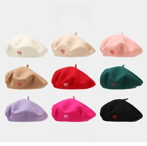 Nine colors of wool berets with heart embroidery showing soft texture and variety