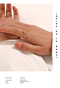 Detail of elegant 18K gold plated snake-shaped open ring worn on a finger