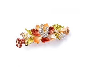 Detailed macro view of a vintage champagne flower hair clip with enamel and crystals
