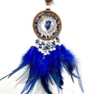 Detail of dream catcher with blue natural stones, woven net, and soft feathers